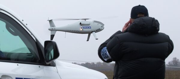 Сотрудник ОБСЕ наблюдает за работой беспилотника на юго-востоке Украины. 23 октября 2014 года - Sputnik Afrique