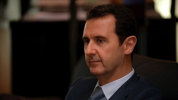 Syria's President Bashar al-Assad is seen during an interview with French magazine Paris Match,in Damascus,in this handout released by Syria's national news agency SANA on December 4, 2014. - Sputnik Afrique