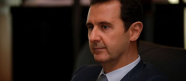 Syria's President Bashar al-Assad is seen during an interview with French magazine Paris Match,in Damascus,in this handout released by Syria's national news agency SANA on December 4, 2014. - Sputnik Afrique