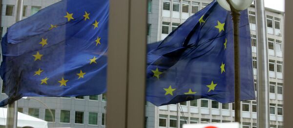 The EU nations flags are mirrored in the windows of the EU Council headquarters ahead of a two-day EU summit in Brussels, Wednesday March 12, 2008 - Sputnik Afrique