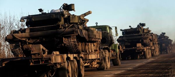 Military trucks from the Ukrainian armed forces transport tanks on the road near Artemivsk, eastern Ukraine, February 24, 2015 - Sputnik Afrique