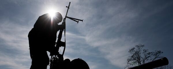 A Ukrainian soldier stands atop a military vehicle near Artemivsk, eastern Ukraine, Monday, Feb. 23, 2015 - Sputnik Afrique