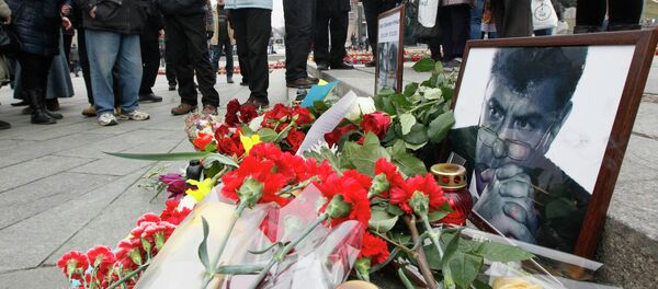 Photos, flowers and candles are left in memory of Boris Nemtsov, who was recently murdered in Moscow, in Independence Square in Kiev, February 28, 2015. - Sputnik Afrique