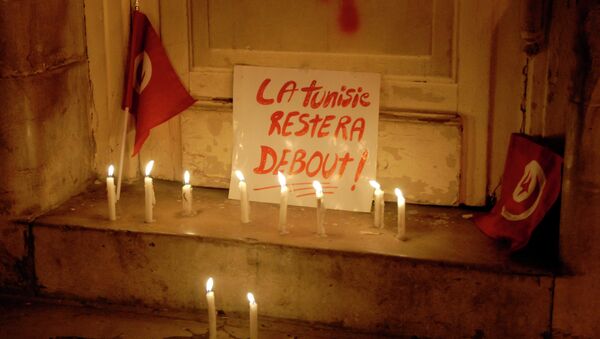 A picture taken on March 18, 2015 shows a placard reading in French Tunisia will remain standing during a rally organised a few hours after an attack on the National Bardo Museum in Tunis. - Sputnik Afrique