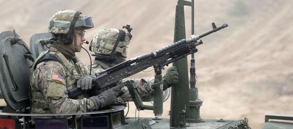 Soldiers of the U.S. Army's 2nd Cavalry Regiment, deployed in Latvia as part of NATO's Operation Atlantic Resolve, ride in armored vehicles named Stryker during a joint military exercise in Adazi February 26, 2015 - Sputnik Afrique