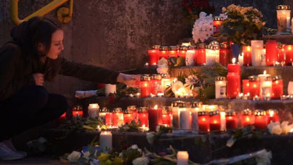 Девушка зажигает свечи в память о погибших во время крушения самолета авиакомпании Germenwings на юге Франции - Sputnik Afrique