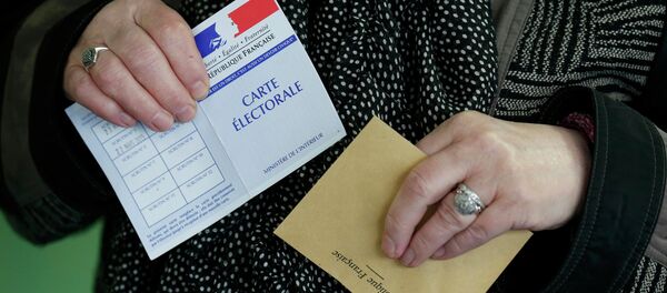 A woman prepares to cast her ballot at a polling station in Henin-Beaumont, northern France, March 29, 2015. France goes to the polls in a two-round departmental election for local officials on March 22 and March 29. - Sputnik Afrique