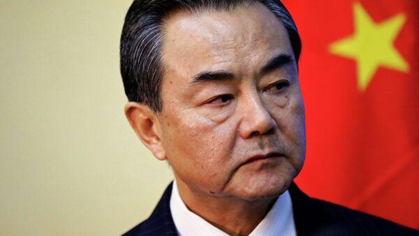 China's Foreign Minister Wang Yi listens during a meeting with Sudan's Foreign Minister Ali Karti in Khartoum January 11, 2015 - Sputnik Afrique