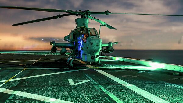 U.S. Marines perform maintenance checks on an AH-1Z Viper helicopter with the 15th Marine Expeditionary Unit (MEU) aboard the USS Anchorage during Amphibious Squadron/Marine Expeditionary Unit Integration Training at night off the coast of San Diego, California, in this picture taken March 2, 2015. - Sputnik Afrique