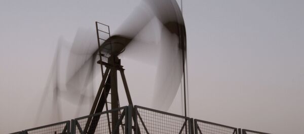 An oil pump jack works at sunset in the desert oil fields of Sakhir, Bahrain, Monday, June 10, 2013 - Sputnik Afrique