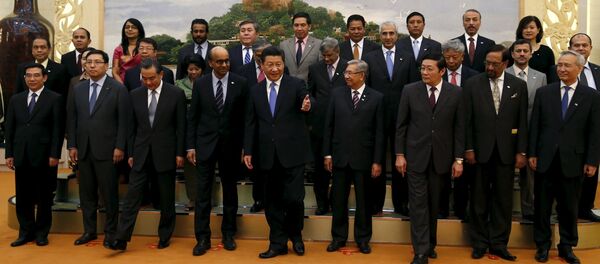 China's President Xi Jinping (front C) guides guests at the Asian Infrastructure Investment Bank launch ceremony at the Great Hall of the People in Beijing in this October 24 - Sputnik Afrique