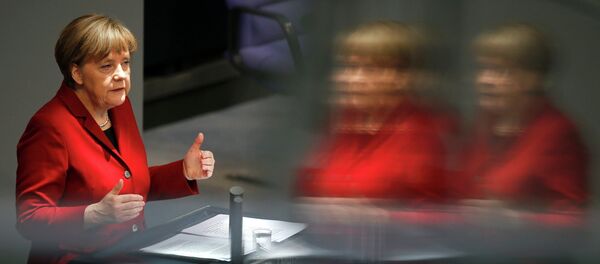German Chancellor Angela Merkel is refelcted in a glass barrier as she gives a speech during a debate at the Bundestag, the lower house of parliament, in Berlin March 19, 2015. - Sputnik Afrique
