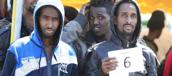 Migrants hold their numbers after disembarking from the Italian Navy ship Chimera in the southern harbour of Salerno - Sputnik Afrique