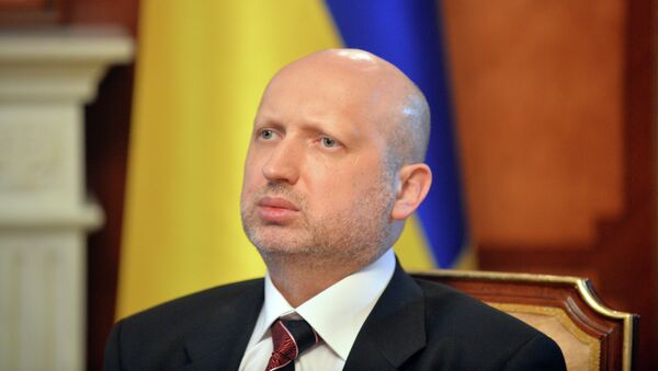 Olexander Turchynov, speaker of the Ukrainian parliament and interim Ukrainian president (C) answers questions during an exlusive interview in Kiev on March 11, 2014 - Sputnik Afrique