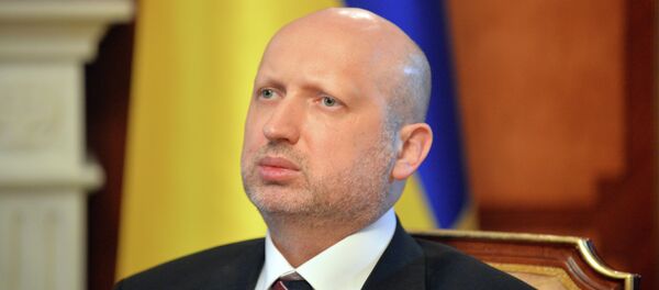 Olexander Turchynov, speaker of the Ukrainian parliament and interim Ukrainian president (C) answers questions during an exlusive interview in Kiev on March 11, 2014 - Sputnik Afrique
