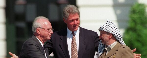 Israeli Prime Minister Yitzhak Rabin, left, and PLO chairman Yasser Arafat, right, shake hands as President Bill Clinton presides over the ceremony marking the signing of the 1993 peace accord between Israel and the Palestinians on the White House lawn, Sept. 13, 1993 - Sputnik Afrique