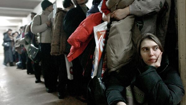 In this image dated Jan.28, 2004, showing a Romanian woman as she leans against the door at the International Office for Migration in Bucharest, Romania, Jan. 28, 2004, waiting in a line to apply for a job in Spain - Sputnik Afrique