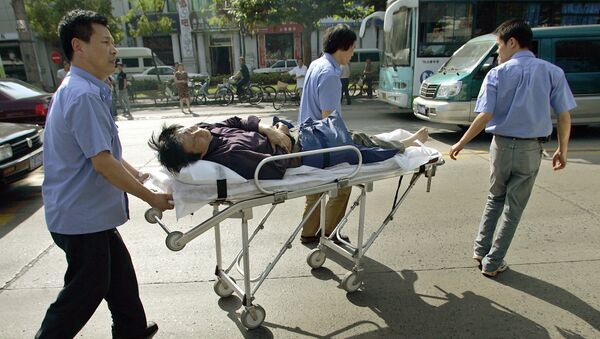 Medical rescuers transport a wounded motorbike rider on a stretcher after a traffic accident in Shanghai, 06 June 2005. - Sputnik Afrique
