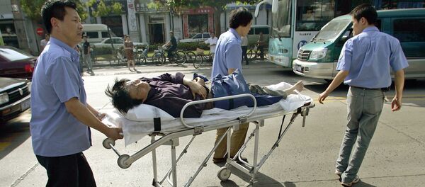 Medical rescuers transport a wounded motorbike rider on a stretcher after a traffic accident in Shanghai, 06 June 2005. Medical rescuers transport a wounded motorbike rider on a stretcher after a traffic accident in Shanghai, 06 June 2005. - Sputnik Afrique