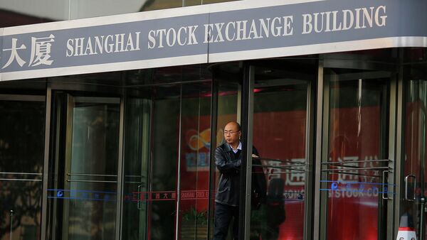 A man walks out of the Shanghai Stock Exchange building at the Pudong financial district in Shanghai - Sputnik Afrique