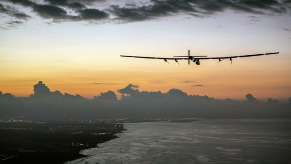 In this photo provided by Jean Revillard, Solar Impulse 2, a plane powered by the sun's rays and piloted by Andre Borschberg, approaches Kalaeloa Airport near Honolulu, Friday, July 3, 2015 - Sputnik Afrique