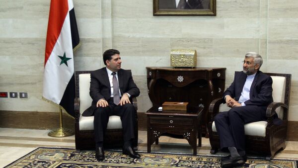 Saeed Jalili, who heads the Iranian Supreme National Security Council, meets with Syrian Prime Minister Wael al-Halqi - Sputnik Afrique