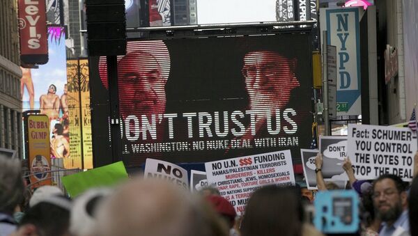 An image of Iranian leaders is projected on a giant screen in front of demonstrators during a rally apposing the nuclear deal with Iran in Times Square in the Manhattan borough of New York City - Sputnik Afrique
