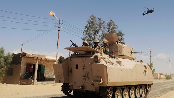 In this Tuesday, May 12, 2013 file photo, Egyptian Army soldiers patrol in an armored vehicle backed by a helicopter gunship during a sweep through villages in in Sheikh Zuweyid, northern Sinai, Egypt - Sputnik Afrique