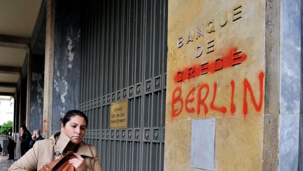A woman passes by the Bank of Greece headquarters where 'Greece' was changed to 'Berlin' during a 24-hour general strike in Athens on February 7, 2012. - Sputnik Afrique