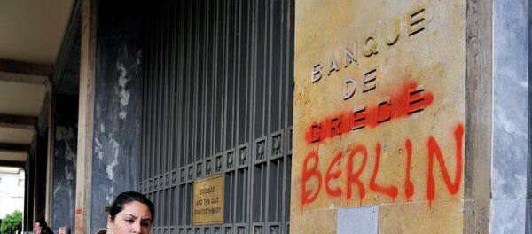 A woman passes by the Bank of Greece headquarters where 'Greece' was changed to 'Berlin' during a 24-hour general strike in Athens on February 7, 2012. - Sputnik Afrique