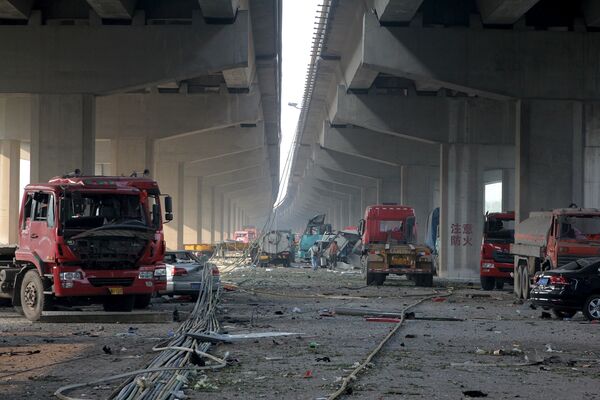 Damaged vehicles are seen under bridges close to the site of the explosions at Binhai new district, Tianjin, August 13, 2015. - Sputnik Afrique