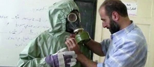 un bénévole portant une masques à gaz apprennent comment réagir face à une attaque chimique, Alep, Syrie - Sputnik Afrique