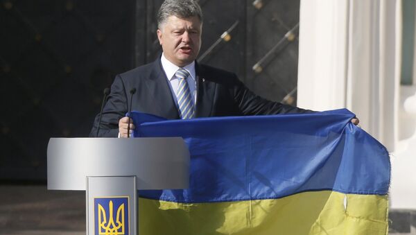 Ukraine's President Petro Poroshenko delivers a speech, while holding a flag brought from eastern regions of the country where a military conflict takes place, during a ceremony marking the Day of the State Flag, on the eve of the Independence Day, in Kiev, Ukraine, August 23, 2015. - Sputnik Afrique