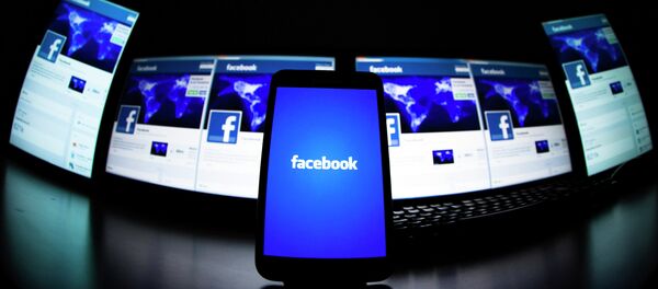 The loading screen of the Facebook application on a mobile phone is seen in this photo illustration taken in Lavigny May 16, 2012. - Sputnik Afrique