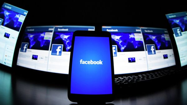 The loading screen of the Facebook application on a mobile phone is seen in this photo illustration taken in Lavigny May 16, 2012. - Sputnik Afrique