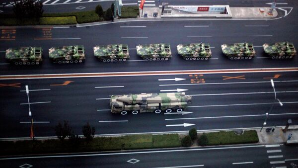 Military vehicle carrying a DF-21D carrier-killer missile, bottom, and other Chinese military vehicles head towards Tiananmen Square - Sputnik Afrique