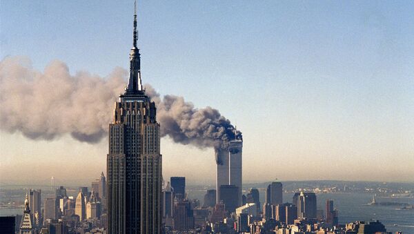 In this Sept. 11, 2001, file photo, the twin towers of the World Trade Center burn behind the Empire State Building in New York. - Sputnik Afrique