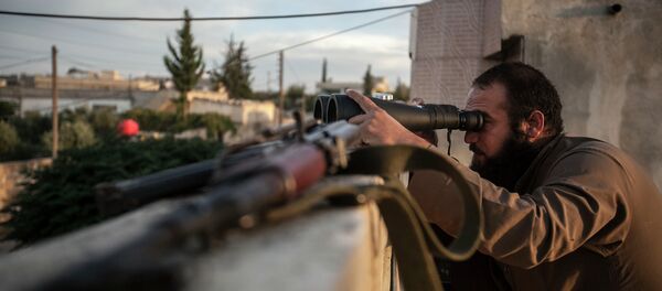 In this Thursday, Sept. 19, 2013 photo, a Syrian opposition fighter watches over as heavy fighting breaks out in in the Idlib province countryside, Syria - Sputnik Afrique