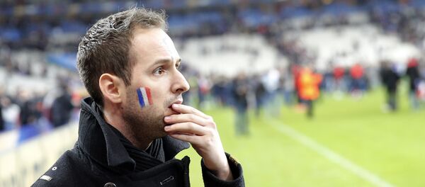 A French supporter reacts after invading the pitch of the Stade de France stadium at the end of the international friendly soccer match between France and Germany in Saint Denis, outside Paris, Friday, Nov. 13, 2015. - Sputnik Afrique