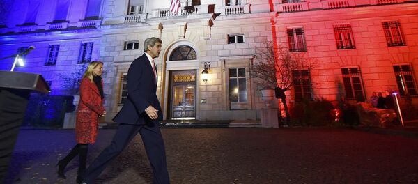 US Secretary of State John Kerry (C), next to US ambassador to France Jane D. Hartley, leaves after delivering a speech at the US embassy illuminated with the colors of the French national flag on November 16, 2015 in Paris. - Sputnik Afrique