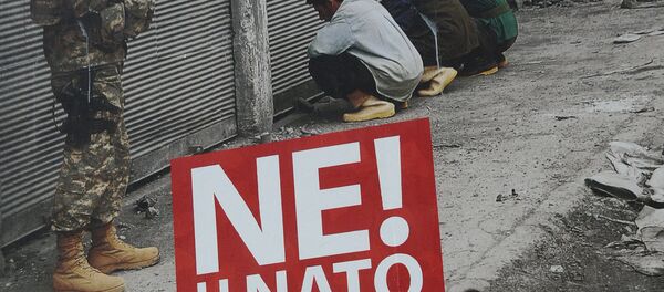 A Montenegrin woman walks past a billboard with the reading, No to NATO in Podgorica, on April 3, 2009 - Sputnik Afrique