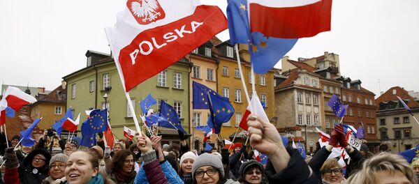 Les gens tiennent les drapeaux européens et polonais lors d'une manifestation à Varsovie, Pologne, le 9 janvier 2016 - Sputnik Afrique