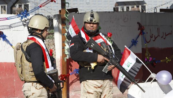 Iraqi soldiers stand guard at a checkpoint  in Baghdad - Sputnik Afrique