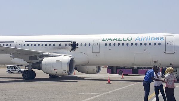A hole is seen in a plane operated by Daallo Airlines as it sits on the runway of the airport in Mogadishu, Somalia - Sputnik Afrique