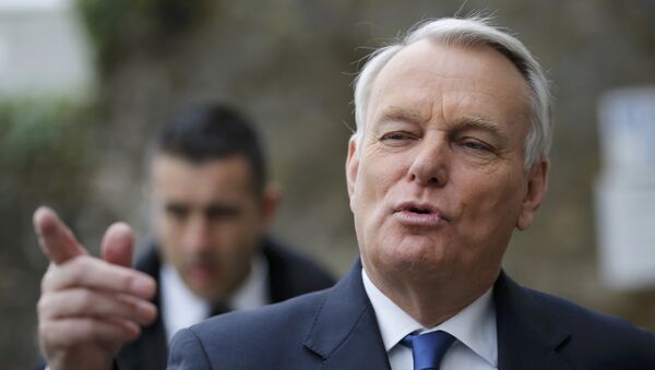 French Prime Minister Jean-Marc Ayrault gestures as he leaves a polling station after casting his ballot during the second round in the French mayoral elections in Nantes, France, in this March 30, 2014 file photo. - Sputnik Afrique