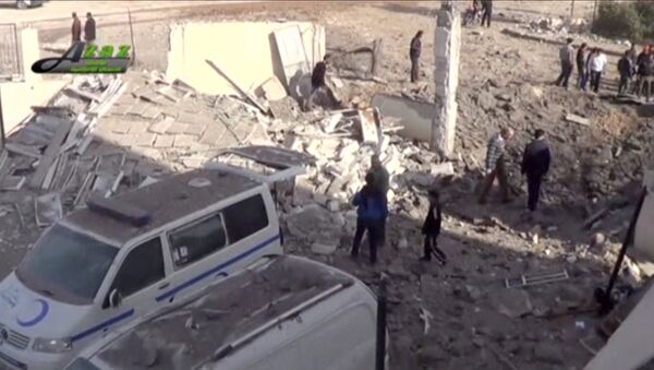 People gather near what is said to be a hospital damaged by missile attacks in Azaz, Aleppo, Syria, February 15, 2016 in this still image taken from a video on a social media website. - Sputnik Afrique
