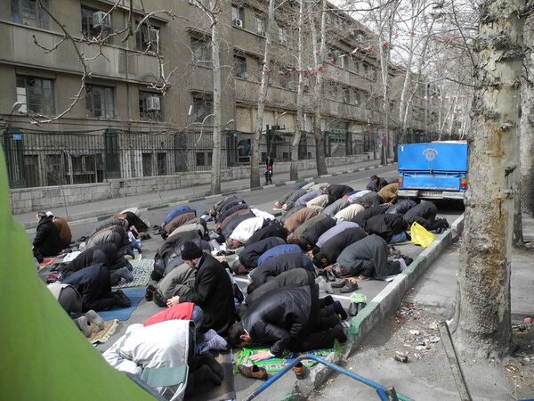 Sur la photo : des hommes priant dans les rues de Téhéran. - Sputnik Afrique