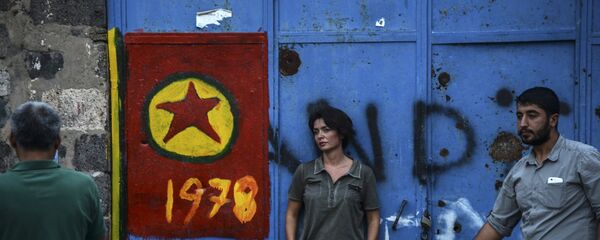 People stand near by the Kurdistan Workers Party (PKK) flag in the center of Diyarbakir on September 14, 2015. - Sputnik Afrique