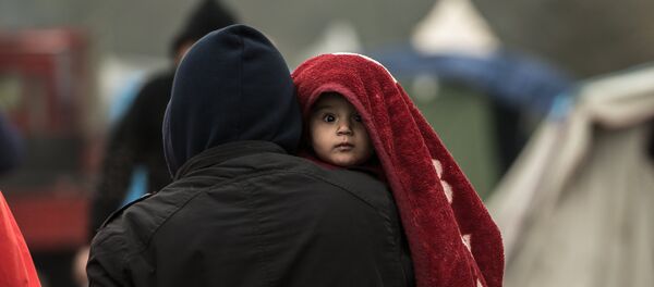 Des migrants dans le camps de Grande-Synthe, prés de Dunkerque le 20 janvier 2016, - Sputnik Afrique