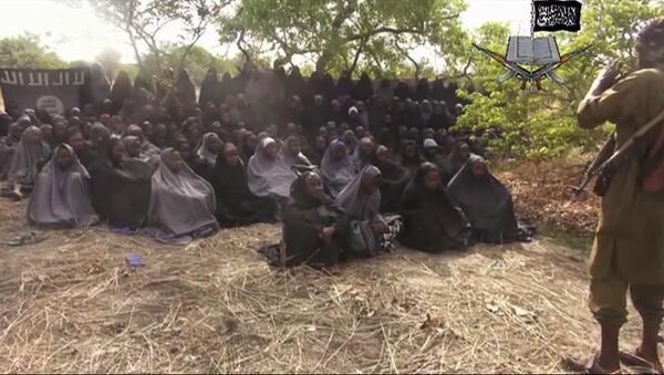 This Monday, May 12, 2014, file image taken from video by Nigeria's Boko Haram terrorist network, shows the alleged missing girls abducted from the northeastern town of Chibok. Islamic extremists in Nigeria have seized Chibok, forcing thousands of residents to flee the northeastern town from which the insurgents kidnapped nearly 300 schoolgirls in April. - Sputnik Afrique